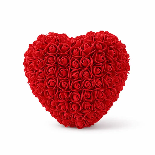 Heart-shaped arrangement of red roses on a white background